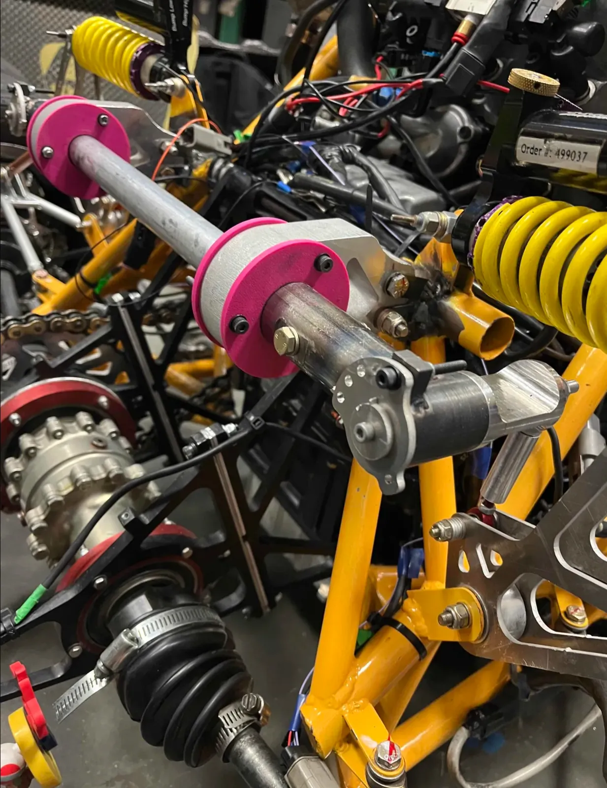 Machined anti-roll bar with pink clocking plate installed on the car