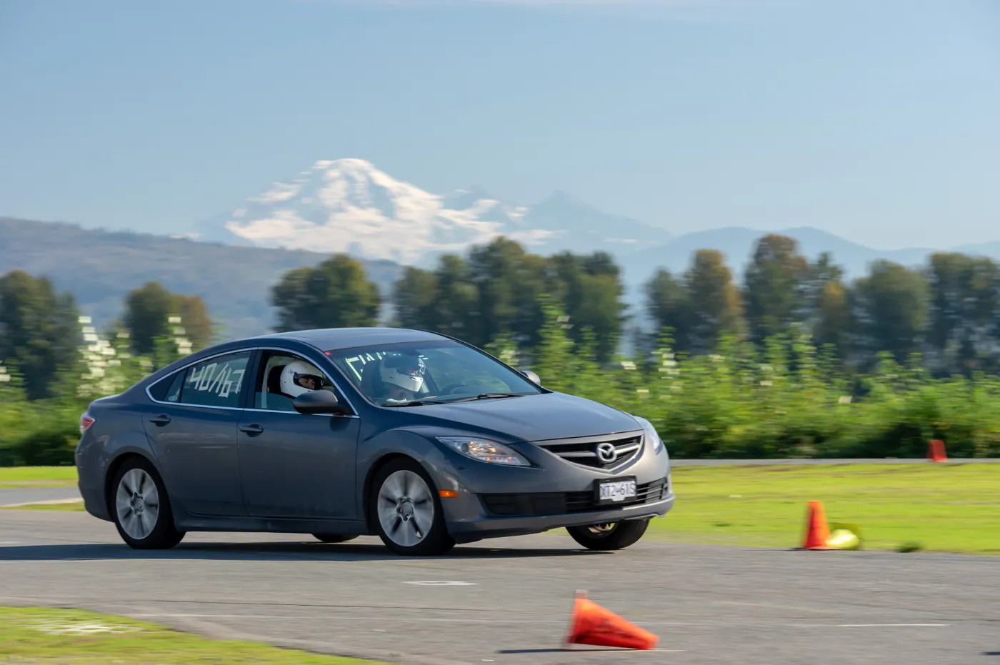 Nathan's grey sedan at an autocross event with Mount Baker behind