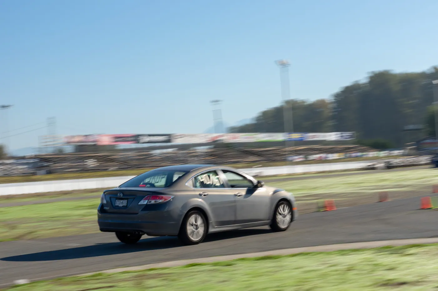 Nathan's grey sedan at speed on an autocross course