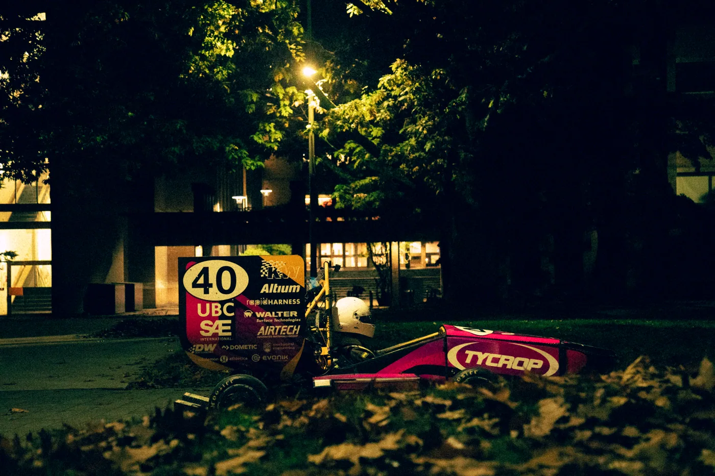 Nathan driving the 2026 car at night under a streetlight on UBC campus